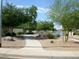 Paved walking path and lush landscaping alongside a tranquil community pond at 10387 W Runion Dr, Peoria, AZ 85382