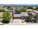 Stunning aerial view of a home showcasing its well-manicured landscaping and attached three car garage at 10504 E Diamond Ave, Mesa, AZ 85208