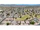 Expansive aerial view of a community with well-maintained homes and scenic mountain views at 10504 E Diamond Ave, Mesa, AZ 85208