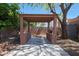 Inviting backyard features a covered patio and lush landscaping for outdoor relaxation and entertaining at 10504 E Diamond Ave, Mesa, AZ 85208
