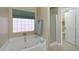 Bright bathroom features a soaking tub, separate shower, and private toilet room for convenience at 10504 E Diamond Ave, Mesa, AZ 85208