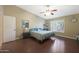 Bright bedroom offers wood floors, vaulted ceiling, and ample natural light through shuttered windows at 10504 E Diamond Ave, Mesa, AZ 85208