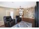 Spacious living room with hardwood floors and a custom shelving unit, perfect for entertaining at 10504 E Diamond Ave, Mesa, AZ 85208