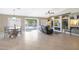 Open-concept living room features tile flooring, built-in shelving, and sliding doors to the backyard at 10504 E Diamond Ave, Mesa, AZ 85208