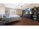 Cozy main bedroom boasts wood floors, vaulted ceiling, and a tranquil ambiance for relaxation at 10504 E Diamond Ave, Mesa, AZ 85208