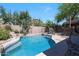 Beautiful backyard pool with rock features and mature landscaping for a relaxing outdoor experience at 10504 E Diamond Ave, Mesa, AZ 85208