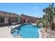 Sparkling pool surrounded by lush landscaping creates a backyard oasis perfect for relaxation and recreation at 10504 E Diamond Ave, Mesa, AZ 85208