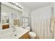 Clean bathroom with modern fixtures, a mirrored wall, and shower curtain for privacy at 1056 S 81St St, Mesa, AZ 85208