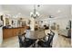 Open-concept dining area showcasing wood floors and seamless flow to kitchen and living spaces at 1056 S 81St St, Mesa, AZ 85208