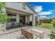 The backyard patio features seating and a grill with a view of the well-maintained lawn and blue sky at 14419 W El Cortez Pl, Surprise, AZ 85387