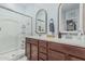 Bright bathroom with a glass shower, double sink vanity, and framed mirrors providing style and function at 14419 W El Cortez Pl, Surprise, AZ 85387