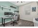 This is a bedroom with dual monitors, shelves with model cars, and a window at 14419 W El Cortez Pl, Surprise, AZ 85387