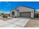 Attractive single-story home with a two-car garage, desert landscaping, and a welcoming facade at 14419 W El Cortez Pl, Surprise, AZ 85387