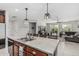Spacious kitchen with island and stainless steel sink open to the living area at 14419 W El Cortez Pl, Surprise, AZ 85387
