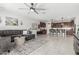 A living area flows to the kitchen that features an island and stainless appliances, perfect for modern living at 14419 W El Cortez Pl, Surprise, AZ 85387