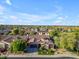 Expansive aerial shot showcases a well-manicured home in a lush, green neighborhood at 15716 W Sheridan St, Goodyear, AZ 85395