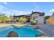 Scenic backyard featuring a refreshing pool and covered patio perfect for entertaining and relaxation at 15716 W Sheridan St, Goodyear, AZ 85395