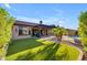 Landscaped backyard features covered patio, built-in grill, artificial turf, and refreshing pool at 15716 W Sheridan St, Goodyear, AZ 85395