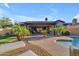 Inviting backyard with outdoor patio, pool and lush tropical landscaping at 15716 W Sheridan St, Goodyear, AZ 85395