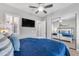 Serene bedroom with mirrored closet, ceiling fan, and plush bedding for relaxation at 15716 W Sheridan St, Goodyear, AZ 85395