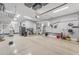 Large and organized garage space with epoxy flooring, storage cabinets, and tool organization at 15716 W Sheridan St, Goodyear, AZ 85395