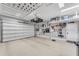Clean and spacious three-car garage featuring ample storage and organized shelving system at 15716 W Sheridan St, Goodyear, AZ 85395