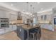 Spacious kitchen with a large island, stainless steel appliances, and pendant lighting at 15716 W Sheridan St, Goodyear, AZ 85395