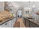 Modern kitchen with granite countertops, stainless steel appliances, and a gas cooktop at 15716 W Sheridan St, Goodyear, AZ 85395
