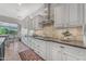 Well-lit kitchen with white cabinets, granite counters, and stainless steel appliances at 15716 W Sheridan St, Goodyear, AZ 85395