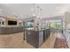 Bright, open kitchen featuring a large island, and seamless access to the living area at 15716 W Sheridan St, Goodyear, AZ 85395