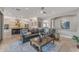 Open concept living room with views into kitchen and adjacent rooms, and comfortable seating at 15716 W Sheridan St, Goodyear, AZ 85395