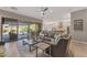 Open concept living room featuring a large sectional and seamless access to an outdoor patio at 15716 W Sheridan St, Goodyear, AZ 85395