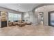 Comfortable living room with natural light, adjacent to an entry door and hallway at 15716 W Sheridan St, Goodyear, AZ 85395