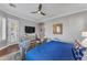 Spacious main bedroom featuring hardwood floors, a sitting area, and exterior views at 15716 W Sheridan St, Goodyear, AZ 85395
