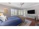 Sunlit main bedroom with hardwood floors, shuttered windows, and ample natural light at 15716 W Sheridan St, Goodyear, AZ 85395