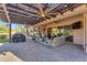 Expansive covered patio featuring ceiling fans with seating and grill, ideal for outdoor entertaining at 15716 W Sheridan St, Goodyear, AZ 85395