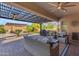 Cozy covered patio with ceiling fans offering a comfortable outdoor experience and a view of backyard and pool at 15716 W Sheridan St, Goodyear, AZ 85395