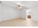Large, sun filled bedroom featuring neutral tile flooring and a view into the ensuite bathroom with wood vanity at 15801 N 29Th St # 16, Phoenix, AZ 85032