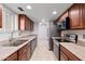 Traditional galley kitchen features stainless steel appliances and tile flooring at 15801 N 29Th St # 16, Phoenix, AZ 85032