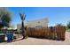 A wooden plank fence lines the backyard, along with a small palm tree and some trash receptacles at 1731 E Moreland St, Phoenix, AZ 85006