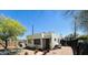 A backyard featuring a brick house, a small outdoor seating arrangement, and a clear blue sky at 1731 E Moreland St, Phoenix, AZ 85006