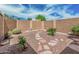 Backyard featuring low-maintenance gravel landscaping and a stone pathway at 1822 W Rose Ln, Phoenix, AZ 85015