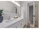 The bathroom has dual sinks, a large mirror, white cabinets, a gray vase with eucalyptus, and a neutral rug at 1822 W Rose Ln, Phoenix, AZ 85015