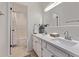 Bathroom boasts double sinks, quartz countertops, and white cabinets and an adjacent shower and bathtub at 1822 W Rose Ln, Phoenix, AZ 85015