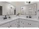 Bright bathroom featuring double sinks, framed mirrors, white cabinetry and white quartz countertops at 1822 W Rose Ln, Phoenix, AZ 85015