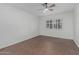 Neutral bedroom with light brown floors, white walls and a ceiling fan at 1822 W Rose Ln, Phoenix, AZ 85015