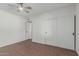Inviting bedroom showcasing a ceiling fan and a spacious closet for ample storage at 1822 W Rose Ln, Phoenix, AZ 85015