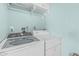 Laundry room features a modern, front-load washing machine and a matching dryer at 1822 W Rose Ln, Phoenix, AZ 85015