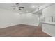 View of the living room with wood floors, a ceiling fan, and white walls at 1822 W Rose Ln, Phoenix, AZ 85015