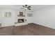 Bright living room featuring a stone fireplace and modern ceiling fan at 1822 W Rose Ln, Phoenix, AZ 85015